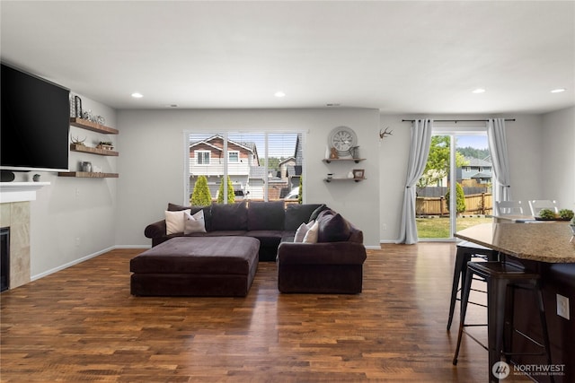 902 Van Ogle Ln NW, Orting, WA 98360 - living area with recessed lighting, dark wood-style flooring, and a tiled fireplace