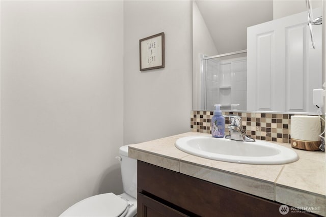 902 Van Ogle Ln NW, Orting, WA 98360 - full bath featuring decorative backsplash, vanity, and a shower with door