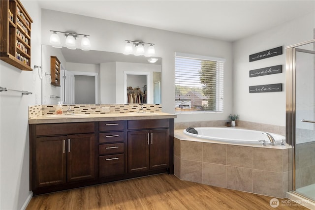 902 Van Ogle Ln NW, Orting, WA 98360 - bathroom featuring a stall shower, wood finished floors, a bath, and double vanity