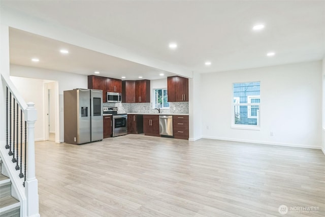 15421 10th Ave SW, Burien, WA 98166 - kitchen with appliances with stainless steel finishes, light countertops, recessed lighting, tasteful backsplash, and light wood-style floors
