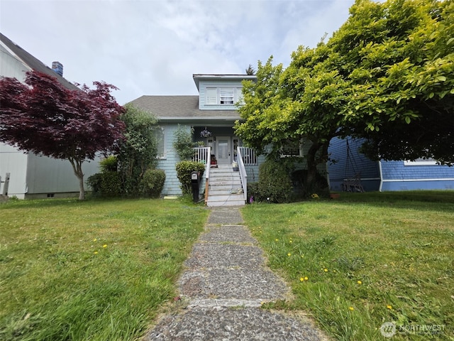 2719 Pacific Ave, Hoquiam, WA 98550 - obstructed view of property with a front lawn, covered porch, and stairway