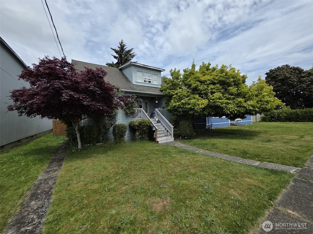 2719 Pacific Ave, Hoquiam, WA 98550 - obstructed view of property featuring covered porch, a front yard, and stairway