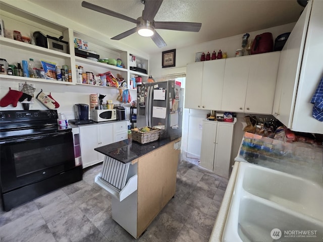 2719 Pacific Ave, Hoquiam, WA 98550 - kitchen featuring black electric range oven, white cabinetry, ceiling fan, a center island, and stainless steel refrigerator with ice dispenser