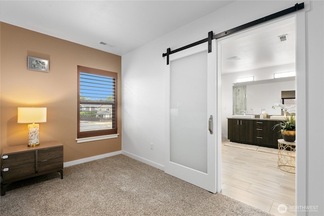 2511 124th Pl SE, Everett, WA 98208 - bedroom featuring a barn door and light colored carpet