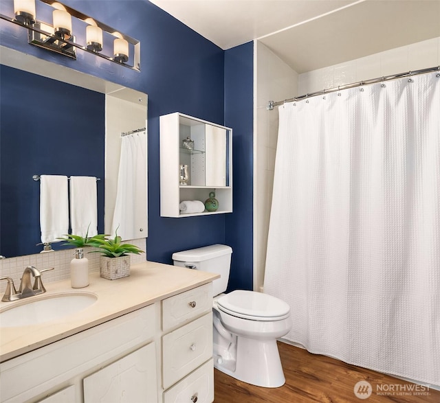 515 Lake St S Unit 205, Kirkland, WA 98033 - bathroom featuring vanity, backsplash, wood finished floors, and a shower with curtain