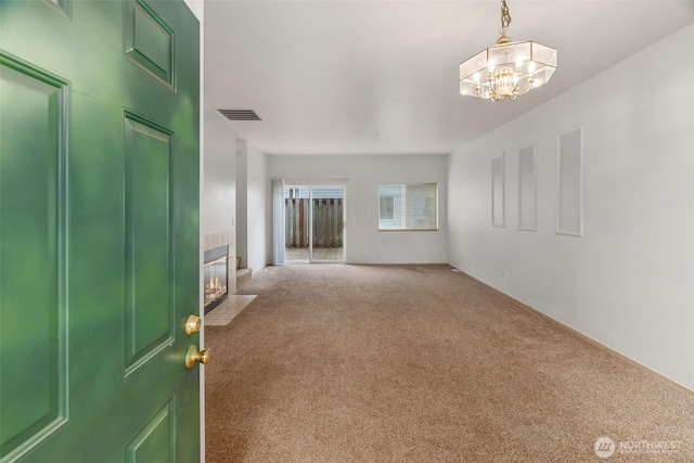 6317 Barstow Ln SE Unit 8, Lacey, WA 98513 - entryway featuring carpet flooring, a tile fireplace, and a chandelier
