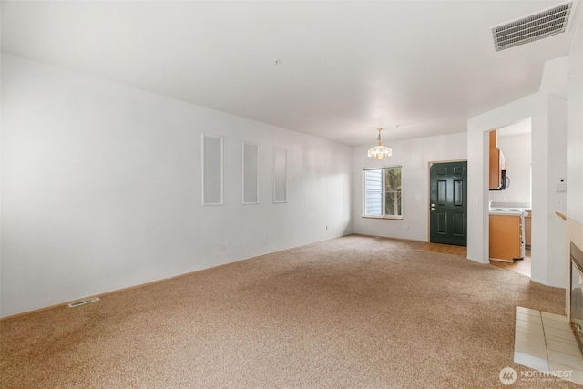 6317 Barstow Ln SE Unit 8, Lacey, WA 98513 - unfurnished room featuring light carpet and a chandelier