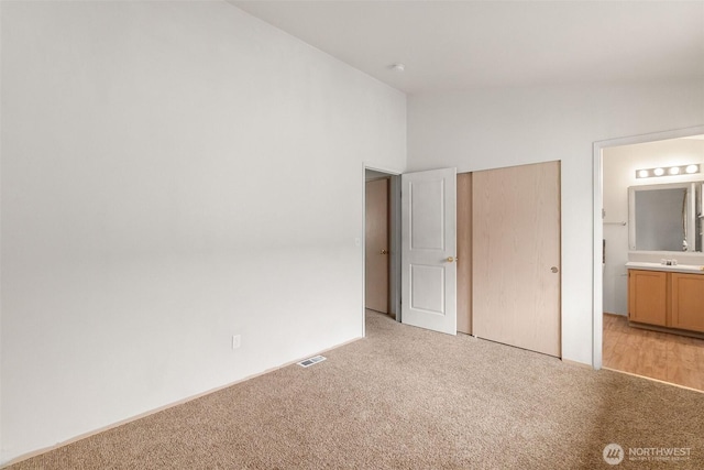 6317 Barstow Ln SE Unit 8, Lacey, WA 98513 - unfurnished bedroom featuring light carpet, connected bathroom, and a closet