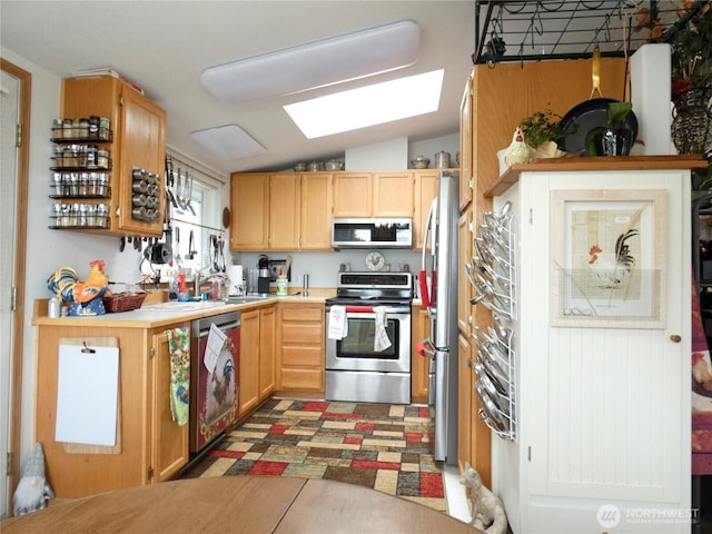 1200 Lincoln St Unit 154, Bellingham, WA 98229 - kitchen featuring stainless steel appliances, a skylight, light countertops, lofted ceiling, and light brown cabinetry