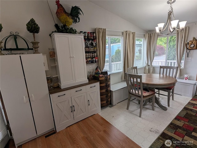 1200 Lincoln St Unit 154, Bellingham, WA 98229 - dining space with lofted ceiling, a chandelier, and light wood-type flooring