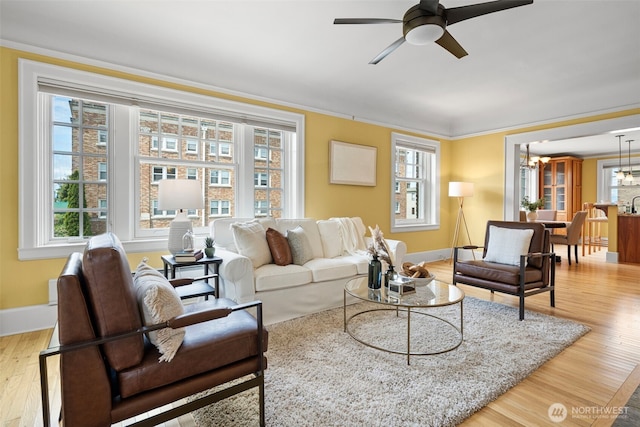 219 N Tacoma Ave Unit A205, Tacoma, WA 98403 - living area with plenty of natural light, wood finished floors, a chandelier, and ornamental molding