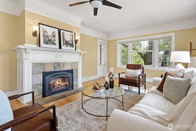 219 N Tacoma Ave Unit A205, Tacoma, WA 98403 - living room featuring wood finished floors, a tile fireplace, ceiling fan, and crown molding
