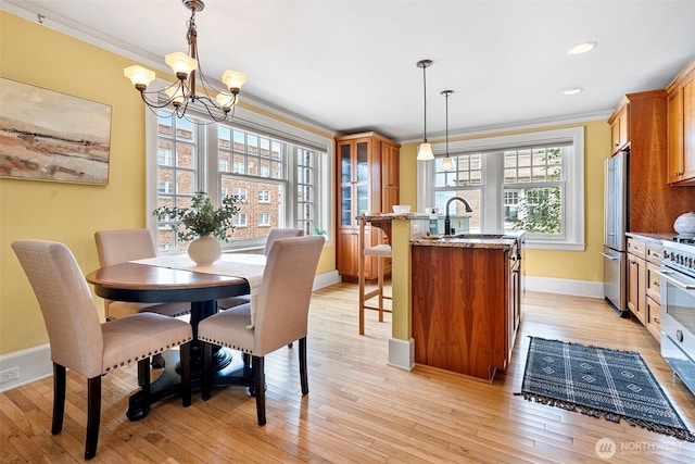 219 N Tacoma Ave Unit A205, Tacoma, WA 98403 - dining space with crown molding, a chandelier, light wood-style flooring, and recessed lighting