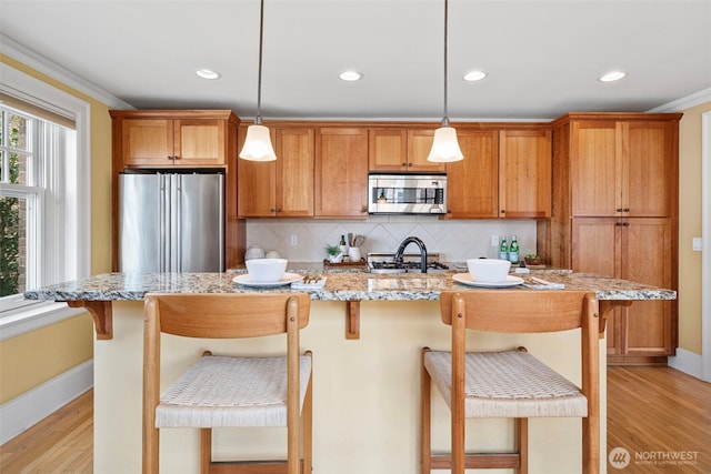 219 N Tacoma Ave Unit A205, Tacoma, WA 98403 - kitchen with appliances with stainless steel finishes, light wood finished floors, backsplash, recessed lighting, and decorative light fixtures