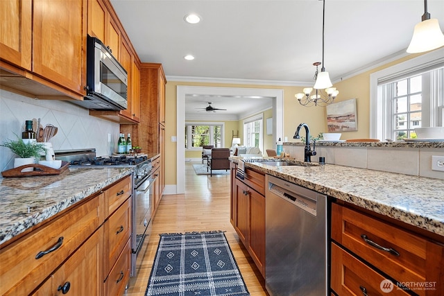 219 N Tacoma Ave Unit A205, Tacoma, WA 98403 - kitchen with appliances with stainless steel finishes, ornamental molding, brown cabinets, tasteful backsplash, and light stone countertops