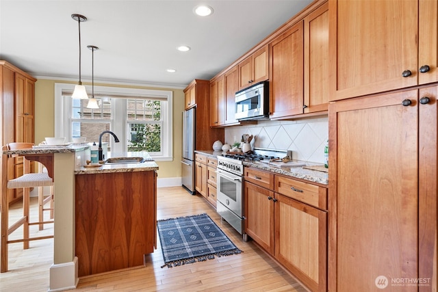 219 N Tacoma Ave Unit A205, Tacoma, WA 98403 - kitchen featuring stainless steel appliances, a kitchen breakfast bar, light wood-style flooring, tasteful backsplash, and recessed lighting