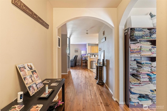 6725 159th St E, Puyallup, WA 98375 - hallway with arched walkways and light wood finished floors