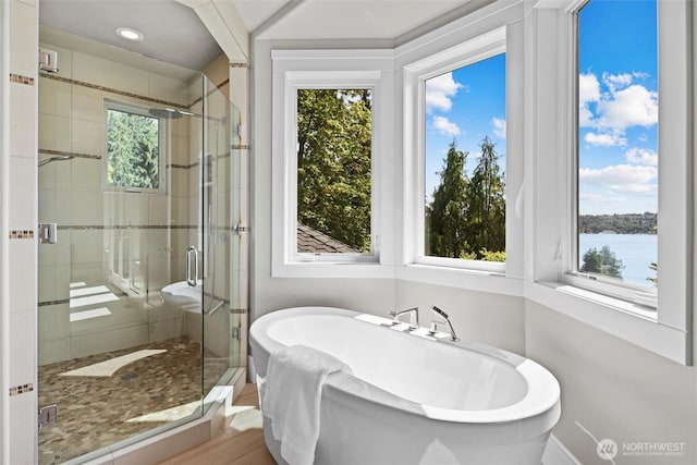 8246 W Mercer Way, Mercer Island, WA 98040 - full bath with healthy amount of natural light, a stall shower, a freestanding bath, and a water view