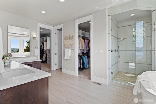 8246 W Mercer Way, Mercer Island, WA 98040 - full bathroom with vanity, a walk in closet, a shower stall, and recessed lighting