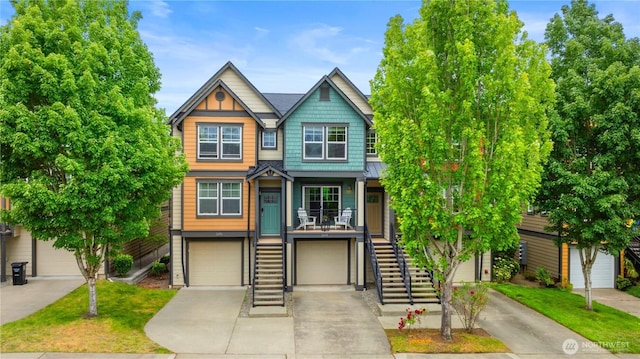 2674 SW Sylvan Heights Dr, Seattle, WA 98106 - view of front facade with stairs, driveway, a standing seam roof, an attached garage, and a metal roof