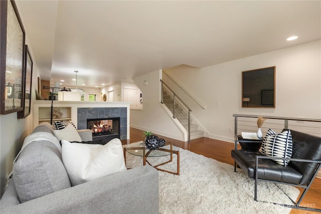 2674 SW Sylvan Heights Dr, Seattle, WA 98106 - living area with wood finished floors, stairs, a fireplace, and recessed lighting