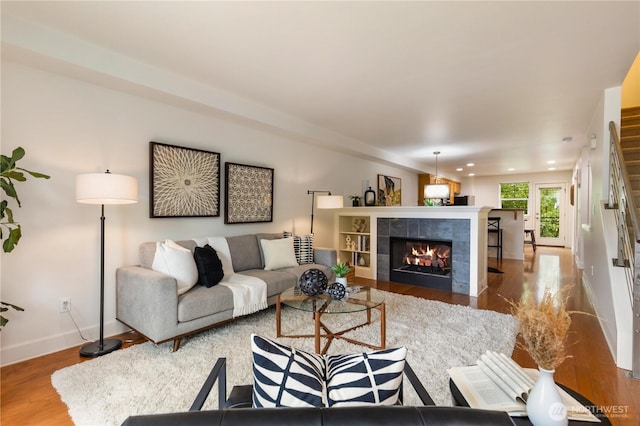 2674 SW Sylvan Heights Dr, Seattle, WA 98106 - living area featuring wood finished floors, a tile fireplace, and recessed lighting