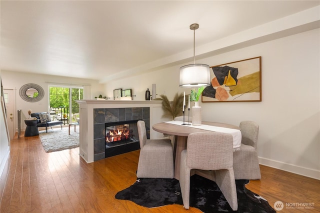 2674 SW Sylvan Heights Dr, Seattle, WA 98106 - dining space with hardwood / wood-style floors and a fireplace