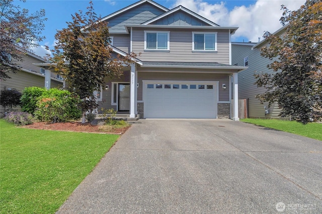 2117 197th Street Ct E, Spanaway, WA 98387 - view of front of property with concrete driveway, a front lawn, an attached garage, stone siding, and board and batten siding