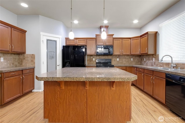 2117 197th Street Ct E, Spanaway, WA 98387 - kitchen with black appliances, tile countertops, brown cabinetry, light wood-style floors, and recessed lighting