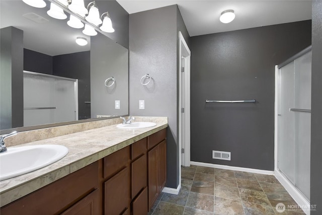 2117 197th Street Ct E, Spanaway, WA 98387 - bathroom with a stall shower, double vanity, and stone finish flooring