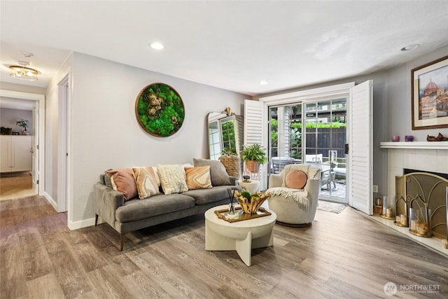 916 3rd Ave Unit A104, Kirkland, WA 98033 - living area with wood finished floors, recessed lighting, and a fireplace