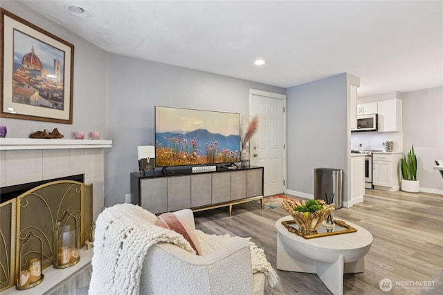 916 3rd Ave Unit A104, Kirkland, WA 98033 - living area with wood finished floors, recessed lighting, and a tile fireplace