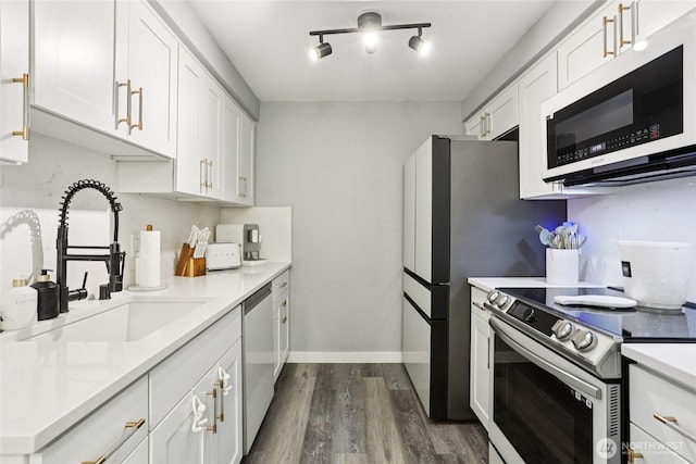 916 3rd Ave Unit A104, Kirkland, WA 98033 - kitchen featuring stainless steel appliances, dark wood finished floors, light countertops, and white cabinetry