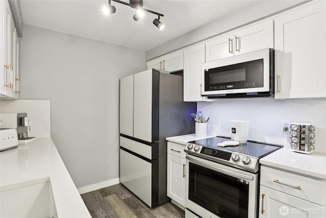 916 3rd Ave Unit A104, Kirkland, WA 98033 - kitchen featuring stainless steel range with electric cooktop, white microwave, dark wood finished floors, and light countertops