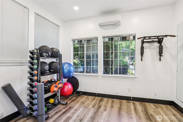 916 3rd Ave Unit A104, Kirkland, WA 98033 - exercise room featuring an AC wall unit, wood finished floors, and recessed lighting