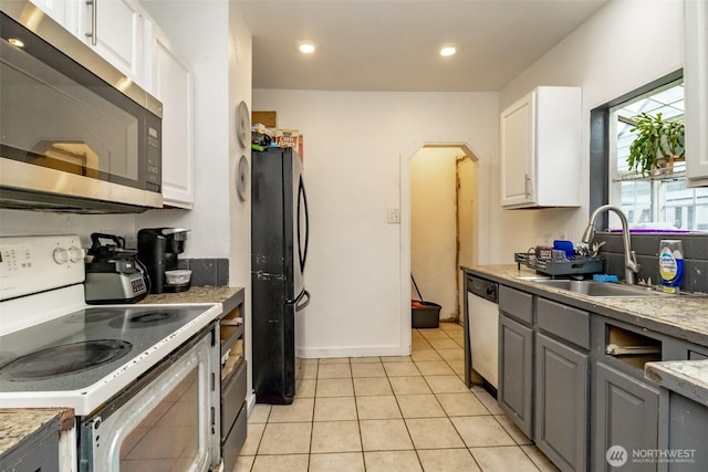 5229 S Thompson Ave, Tacoma, WA 98408 - kitchen with stainless steel microwave, electric stove, freestanding refrigerator, dishwasher, and gray cabinets
