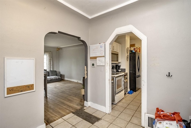 5229 S Thompson Ave, Tacoma, WA 98408 - hallway with arched walkways and light tile patterned floors