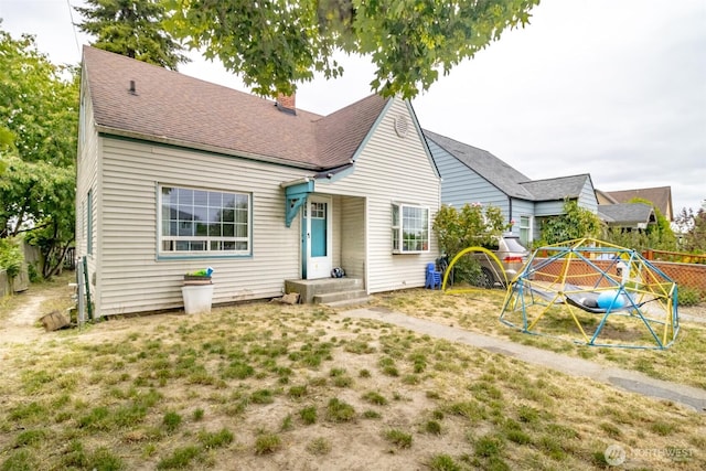 5229 S Thompson Ave, Tacoma, WA 98408 - view of front of property featuring a chimney and roof with shingles