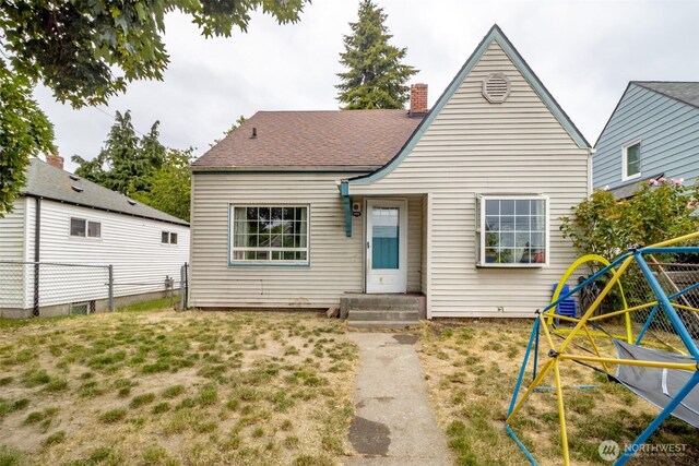 5229 S Thompson Ave, Tacoma, WA 98408 - view of front facade featuring a playground and a chimney