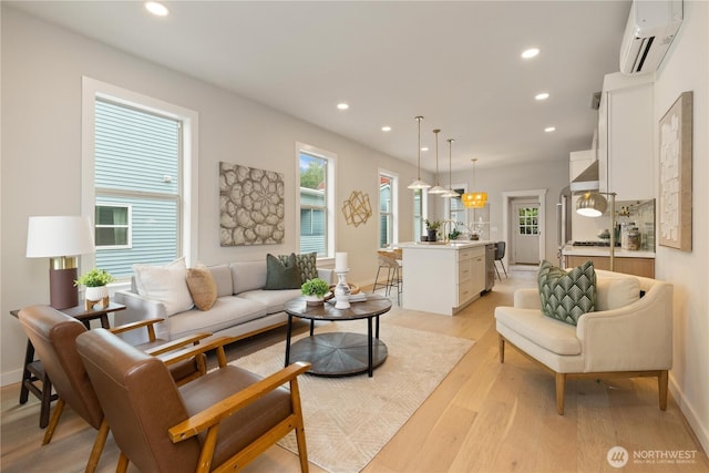 157 26th Ave, Seattle, WA 98122 - living room featuring a wall mounted air conditioner, recessed lighting, and light wood-type flooring