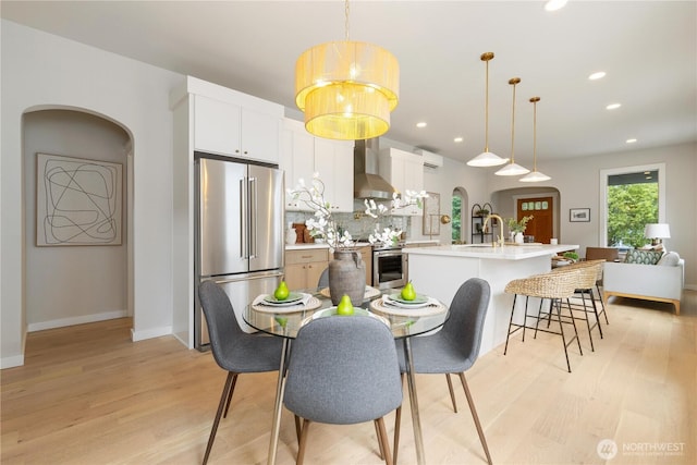 157 26th Ave, Seattle, WA 98122 - dining space featuring arched walkways, light wood-type flooring, and recessed lighting