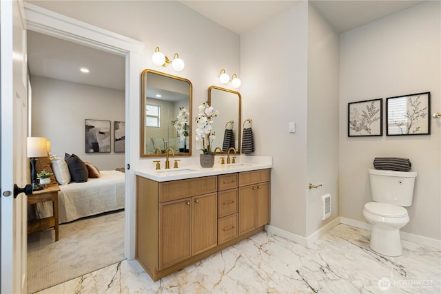 157 26th Ave, Seattle, WA 98122 - bathroom featuring marble look tile flooring, double vanity, recessed lighting, and connected bathroom