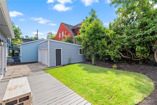 157 26th Ave, Seattle, WA 98122 - view of grassy yard featuring an outdoor structure, a detached garage, and driveway