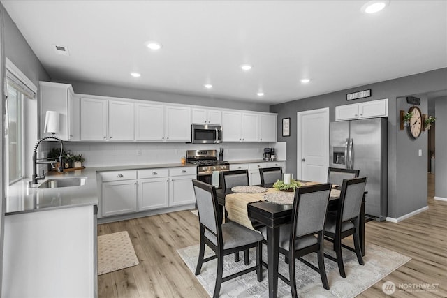 1120 15th Ave, Sultan, WA 98294 - kitchen featuring appliances with stainless steel finishes, light wood-style flooring, white cabinets, and recessed lighting