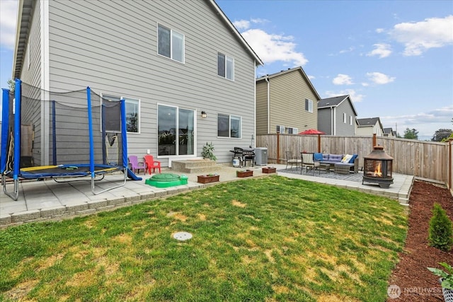 1120 15th Ave, Sultan, WA 98294 - rear view of house with a trampoline, an outdoor hangout area, a patio area, and a fenced backyard