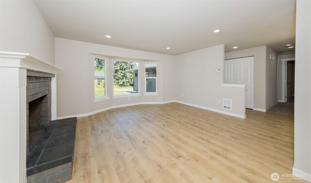 9621 1st Ave SE, Everett, WA 98208 - unfurnished living room with wood finished floors, a brick fireplace, and recessed lighting