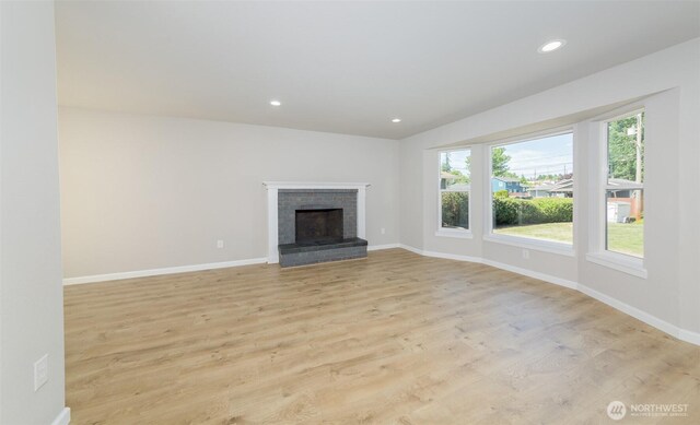 9621 1st Ave SE, Everett, WA 98208 - unfurnished living room with light wood-type flooring, recessed lighting, and a brick fireplace