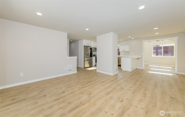 9621 1st Ave SE, Everett, WA 98208 - unfurnished living room featuring light wood-style floors and recessed lighting