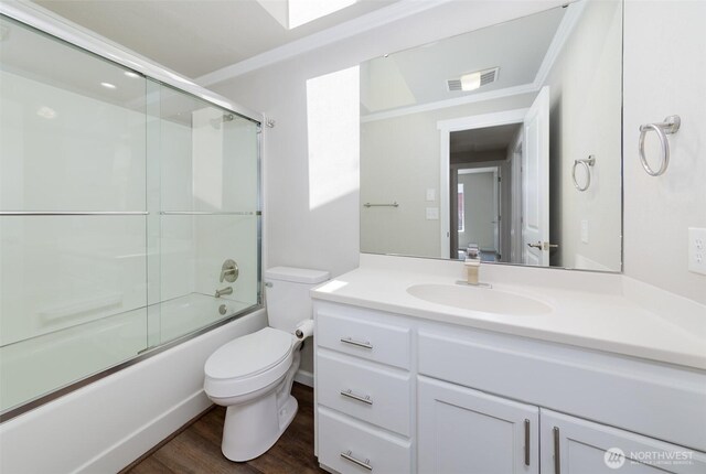 9621 1st Ave SE, Everett, WA 98208 - bathroom with vanity, shower / bath combination with glass door, wood finished floors, and ornamental molding