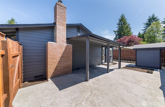 9621 1st Ave SE, Everett, WA 98208 - view of side of property with a patio, a chimney, and an outbuilding
